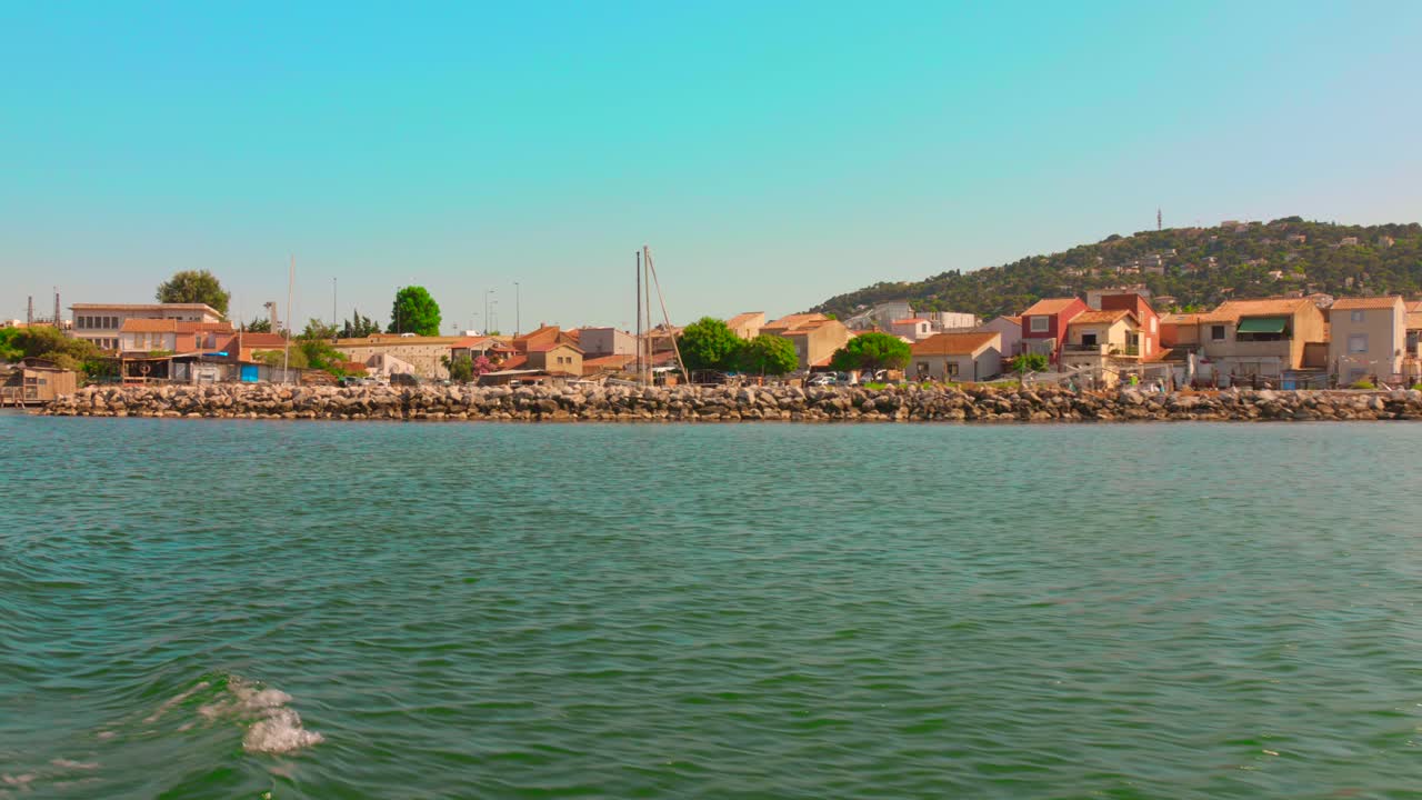 Calm waters of Etang de Thau by Sète under clear blue sky