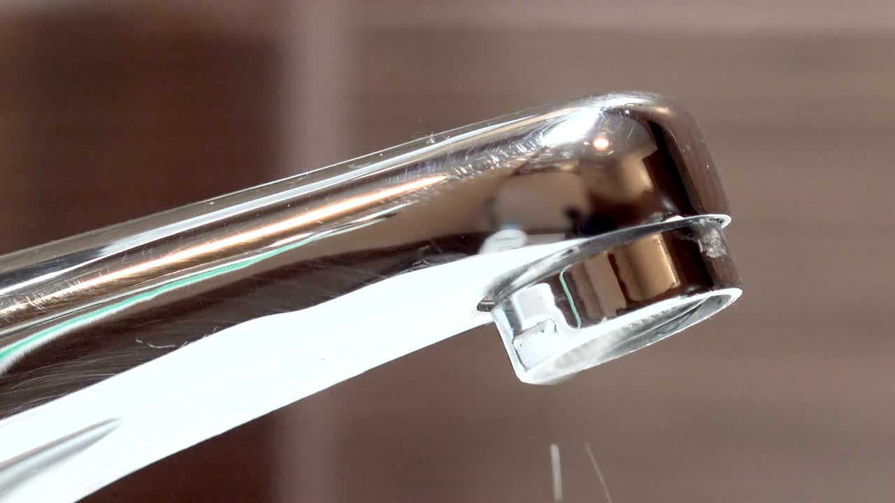Tap closeup with dripping water-drop. Water leaking, saving concept, loop background