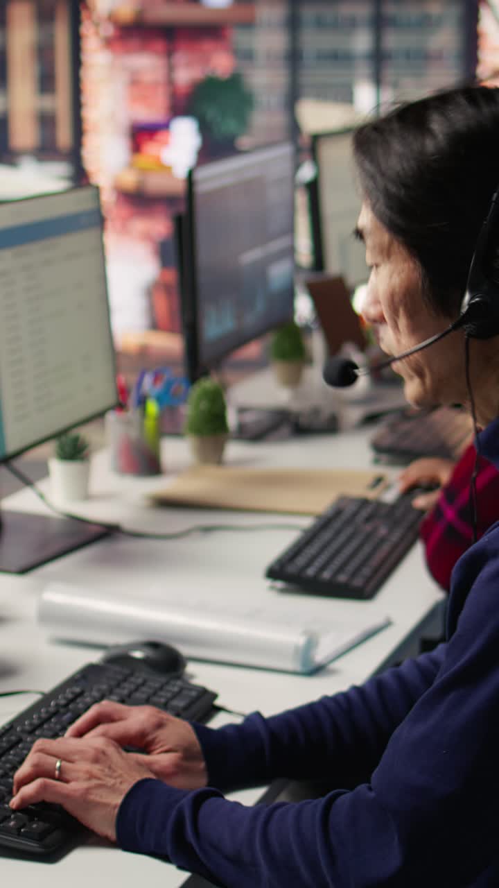Vertical video Experienced call center employee listening to customer inquiries