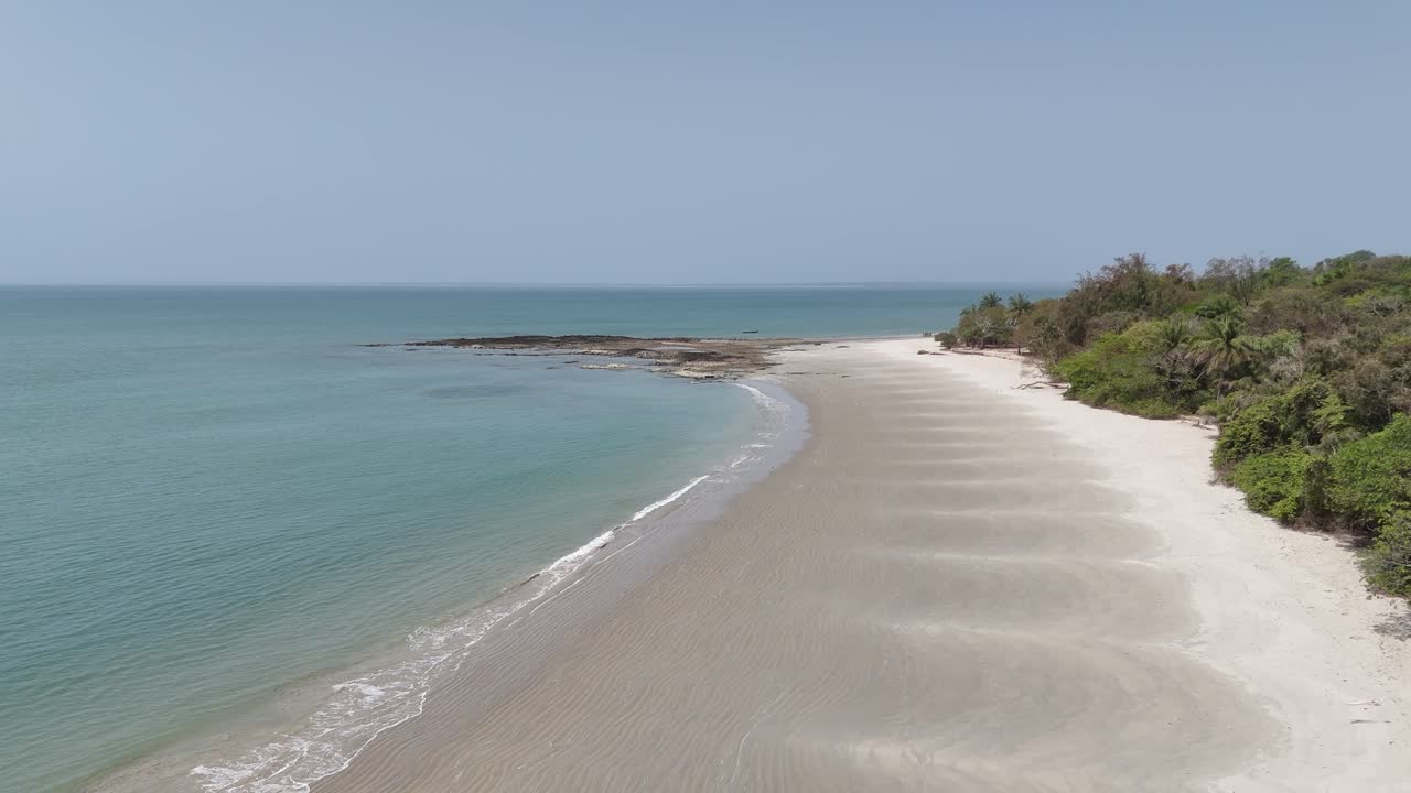 Aerial drone above Long white sand beach stretching along turquoise sea in the Bijagos Islands, West Africa