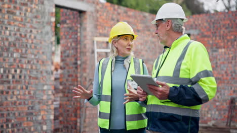 construction engineers discussing building plans