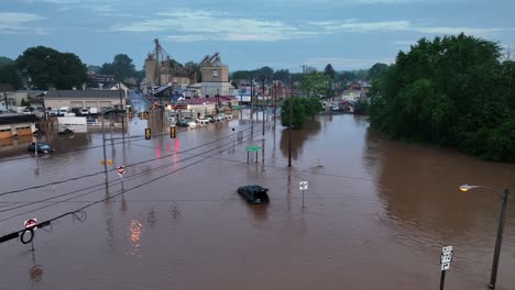 drone footage in pennsylvania with submerged streets and vehicles. destroyed and damaged buildings and cars after heavy rainfall in america. aerial view