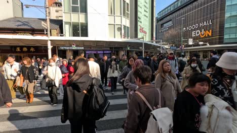 people crossing a busy street in kyoto