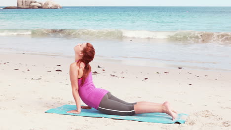 woman stretching her body on the beach