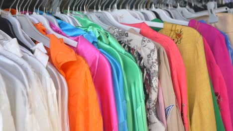 colorful clothes on hangers in a store