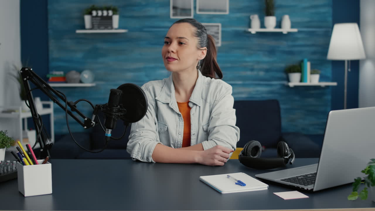 Famous internet podcaster sitting at home studio desk with professional audio equipment