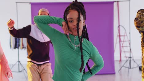portrait of happy diverse male and female dancers dancing in dance studio, slow motion