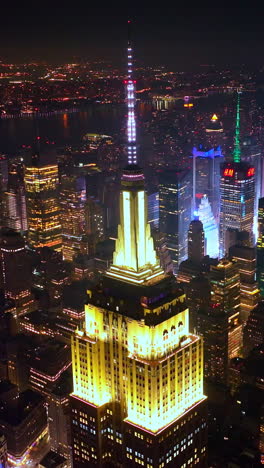 stunning new york at night scenery. eye-catching sight of vibrant metropolis at the backdrop of dark sky. vertical video