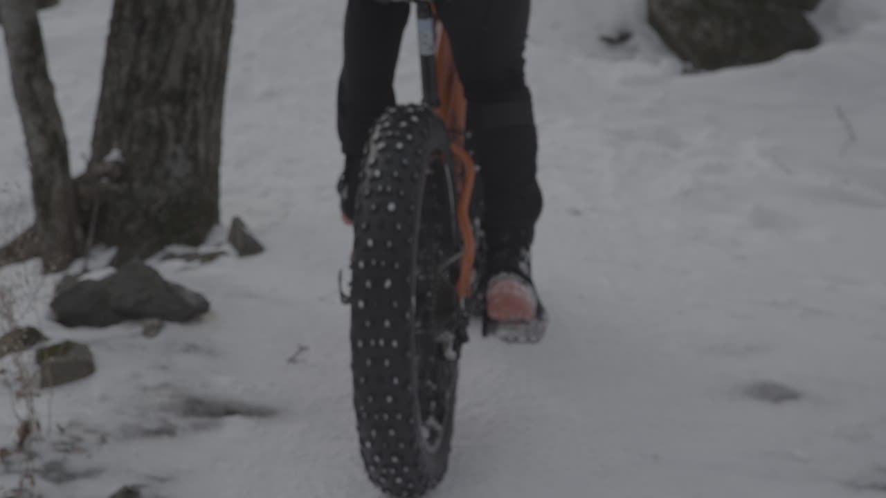Close up pedalling up a hill on a fatbike