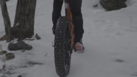 close up pedalling up a hill on a fatbike