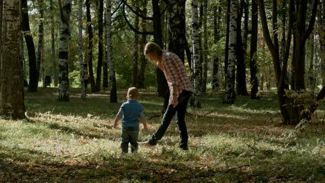 mother with son walking outdoor in autumn