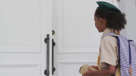 animation of african american girl in scout costume delivering package to biracial woman