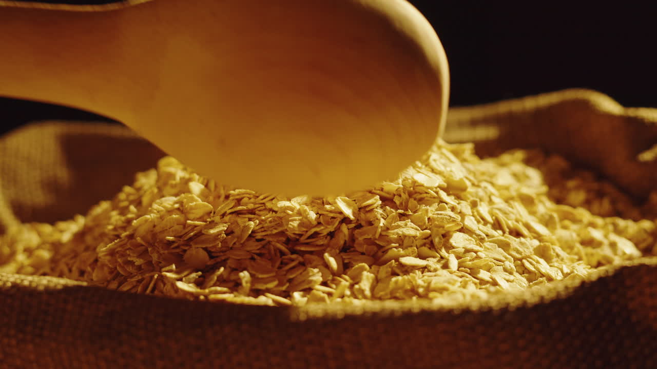 Oats and Oatmeal in a Burlap Sack with a Wooden Scoop