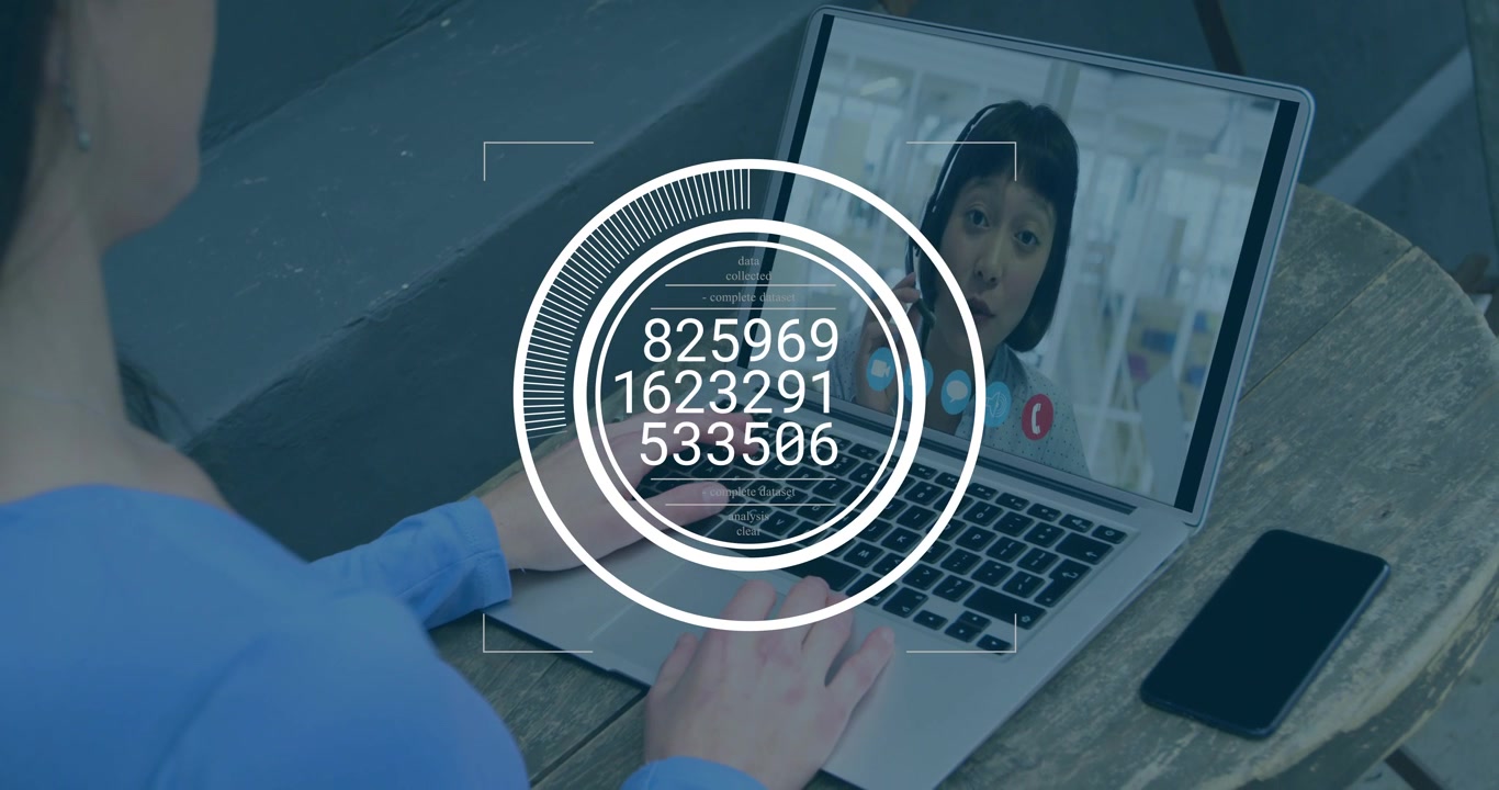 Man sitting at table getting data using laptop watching HUD overlay updating numbers on biz call