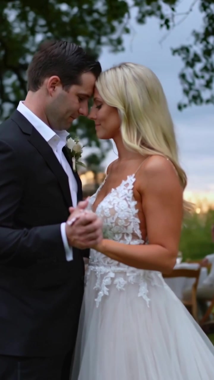 Video verticale: Canzone che invita una coppia in abiti da sposa ad appoggiare le teste e tenersi per mano al ricevimento.