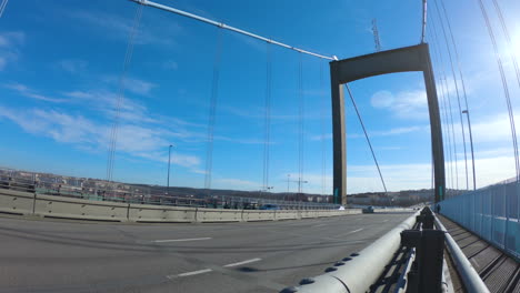 4k shot of gothenburg suspension bridge, älvsborgsbron. traffic cars, busses and trucks driving across the bridge in sweden