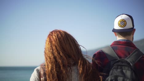 surf couple arriving at the beach