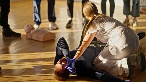 a professional nurse girl demonstrates a change in the position of a lying person during medical care. practical training of a physician