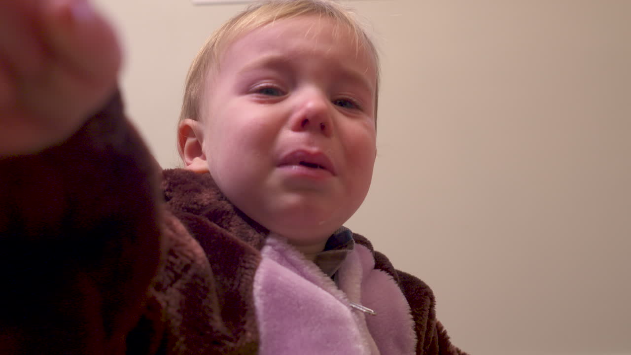 Toddler boy upset and crying starts to calm down
