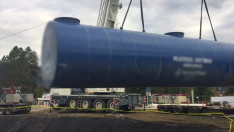 Heavy-Duty-Crane-Lifts-Massive-Diesel-Underground-Tank-into-Pit