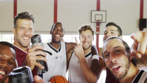 happy basketball players standing in court