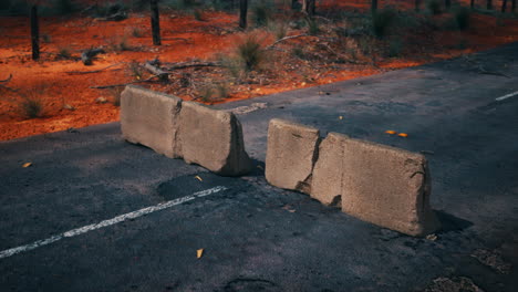 broken concrete barriers on an abandoned road in the australian outback