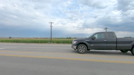 A-road-side-drive-"out-of-the-window"-as-fields-fly-by
