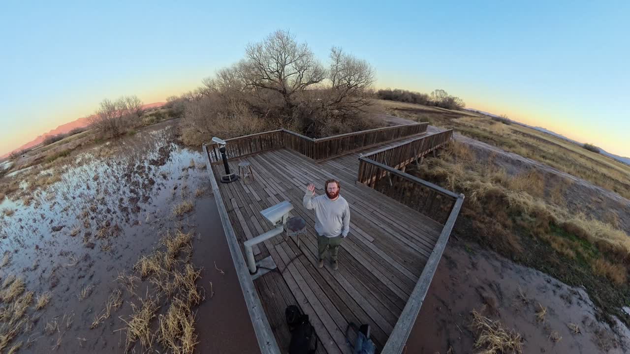 Cold Arizona morning deck on frozen pond Photographer waving.