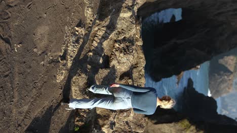 woman at natural bridges, tourist destination on oregon coast - vertical