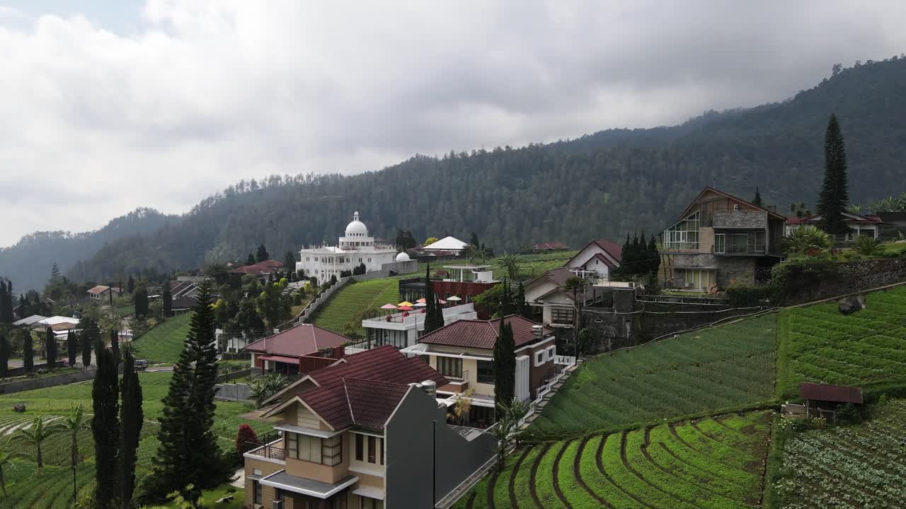 Houses on a Hillside overlooking a Farmland