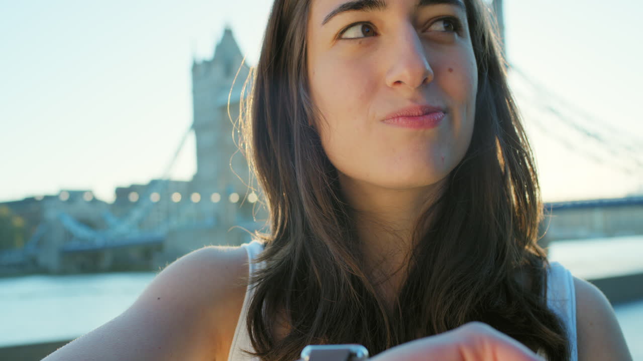 런던에서 시계를 보는 행복한 여성