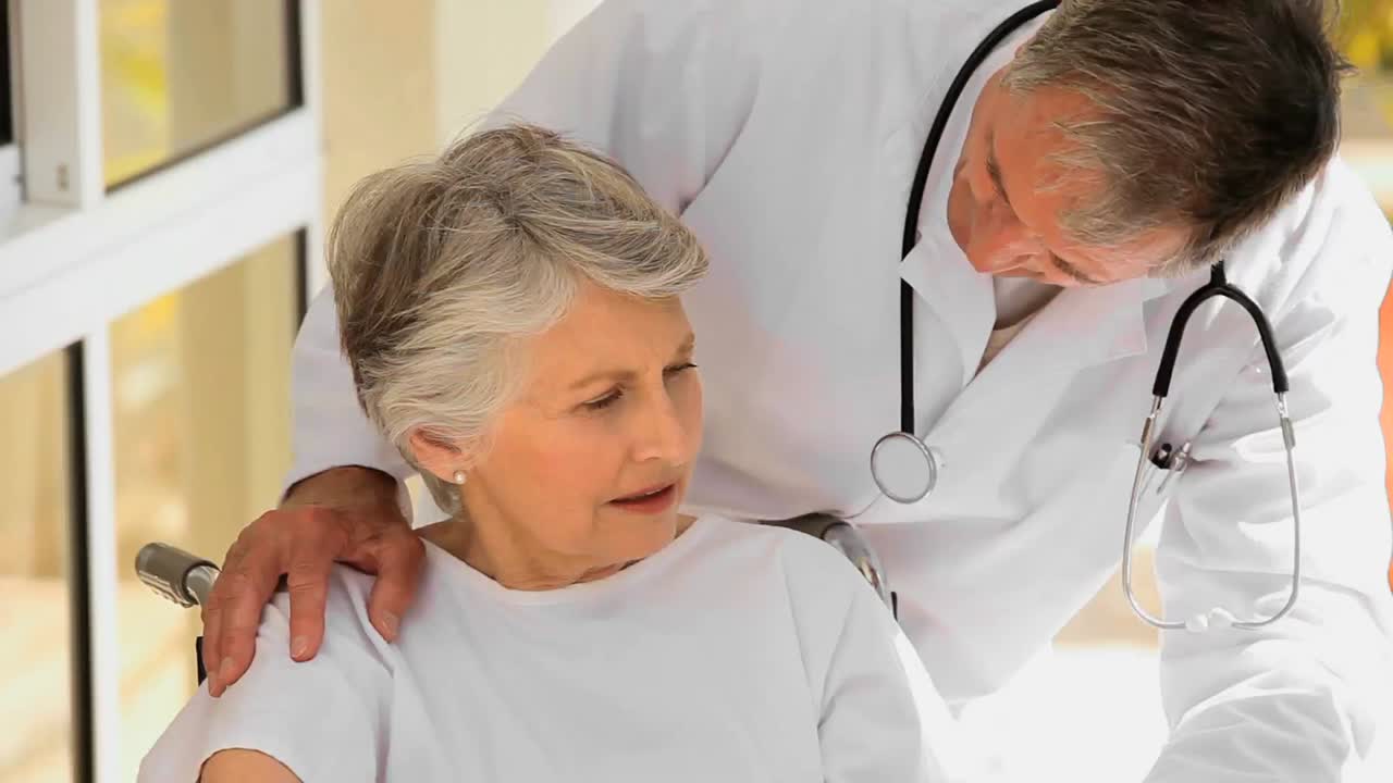 Woman in wheelchair talking with her doctor