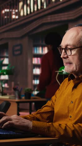 vertical video elderly student breaking library rules with loud music on headset