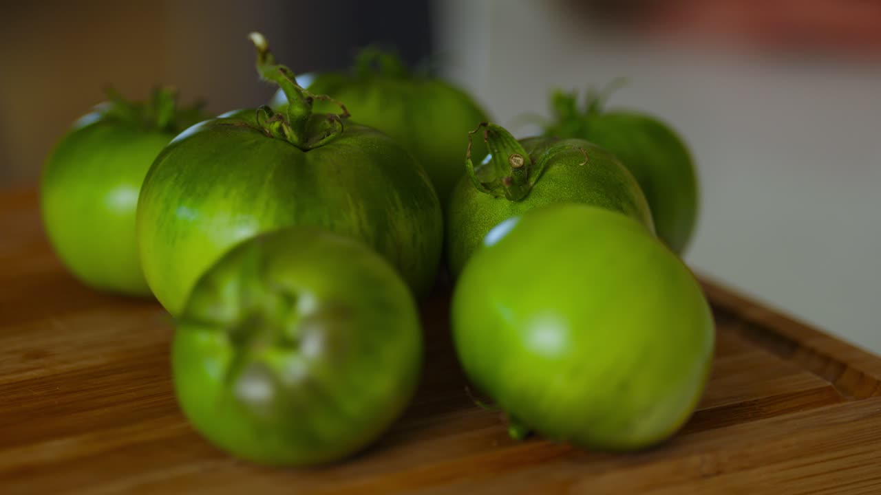 Closeup shot of green tomatoes kept on kitchen table.