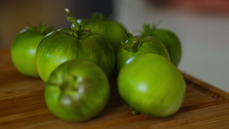 closeup shot of green tomatoes kept on kitchen table.
