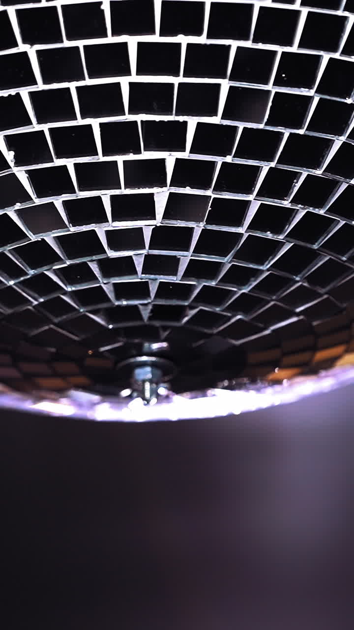 Party lights disco ball. Silver disco ball hanging on the wall