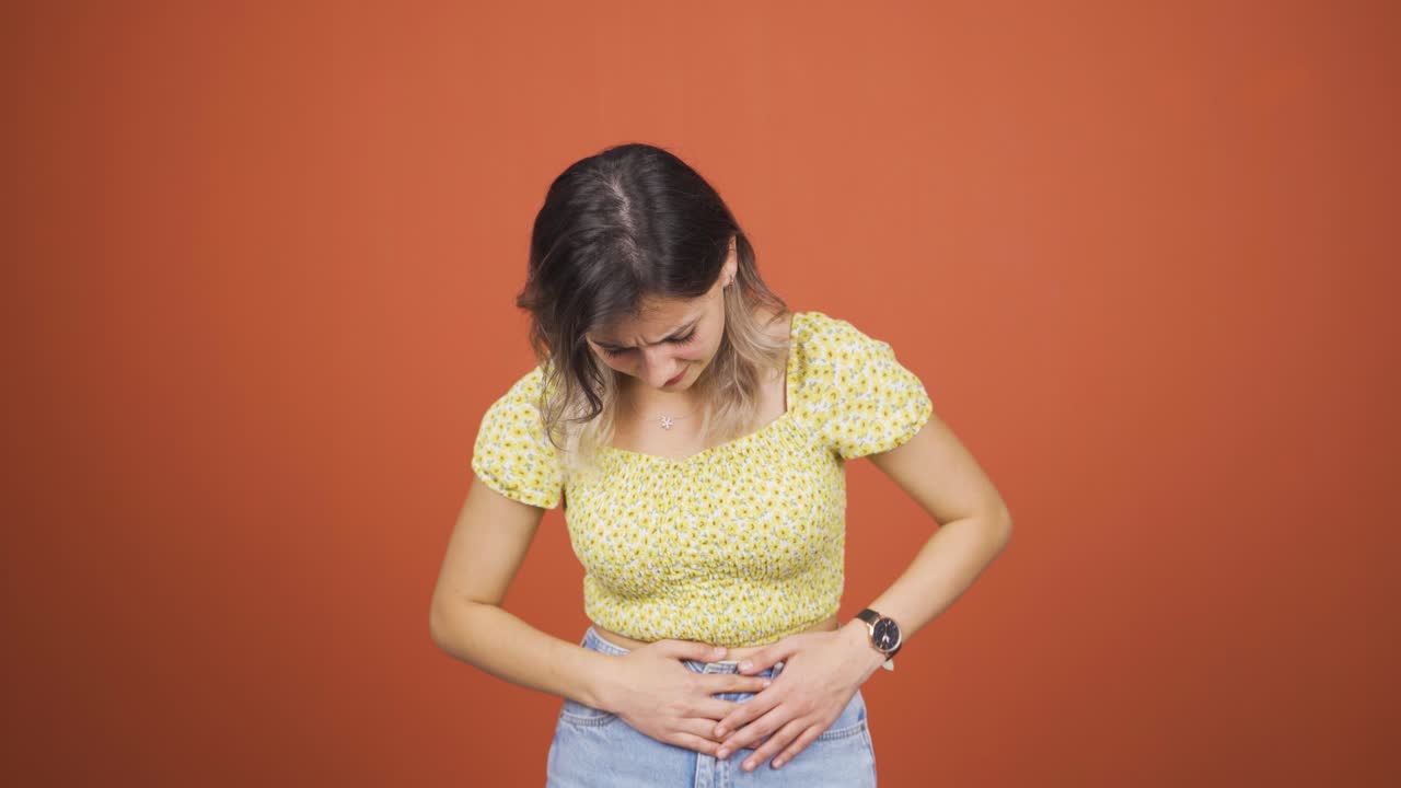 Young woman experiencing stomachache.