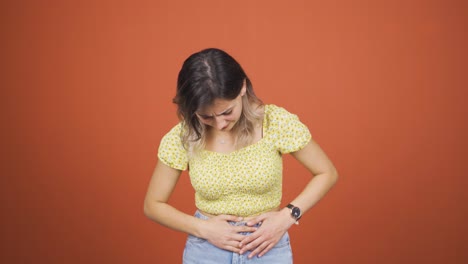 young woman experiencing stomachache.