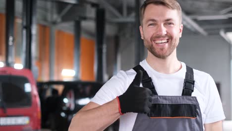 smiling mechanic giving thumbs up in auto repair shop