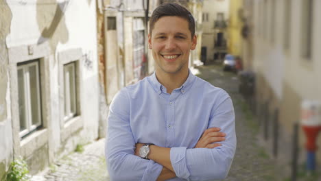 confident young man posing on old city street background