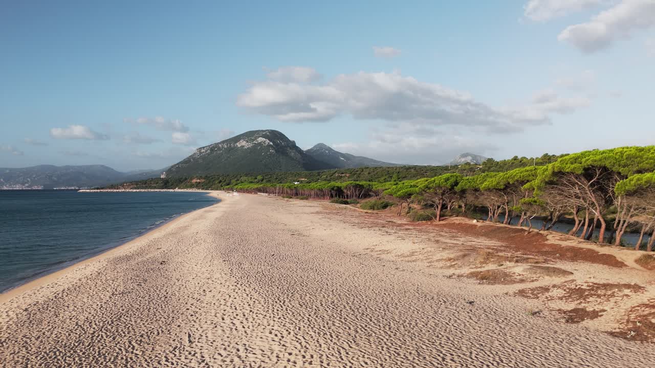 Stunning sandy beach with crystal-clear waters, framed by majestic mountains. This idyllic setting offers a perfect blend of relaxation and adventure for beach lovers and nature enthusiasts.