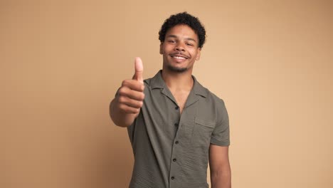 smiling man making thumbs up gesture and nodding to show approval