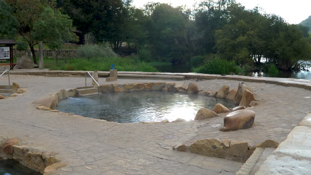 Establishing shot of Muiño da Veiga thermal baths in Ourense, Galicia, Spain