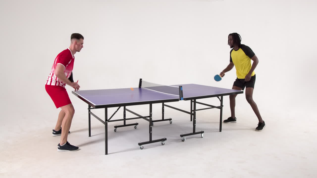 Multiracial male table tennis players serving and passing the ball to each other on white background