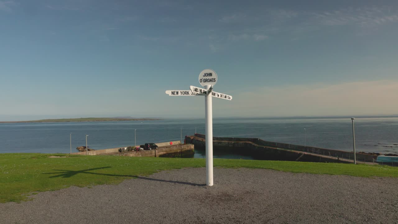 John O'Groats harbour and famous signpost landmark on a summers day