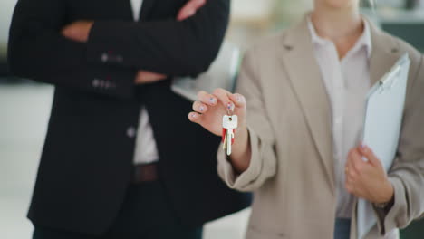 real estate agent holding keys, symbol of dream house