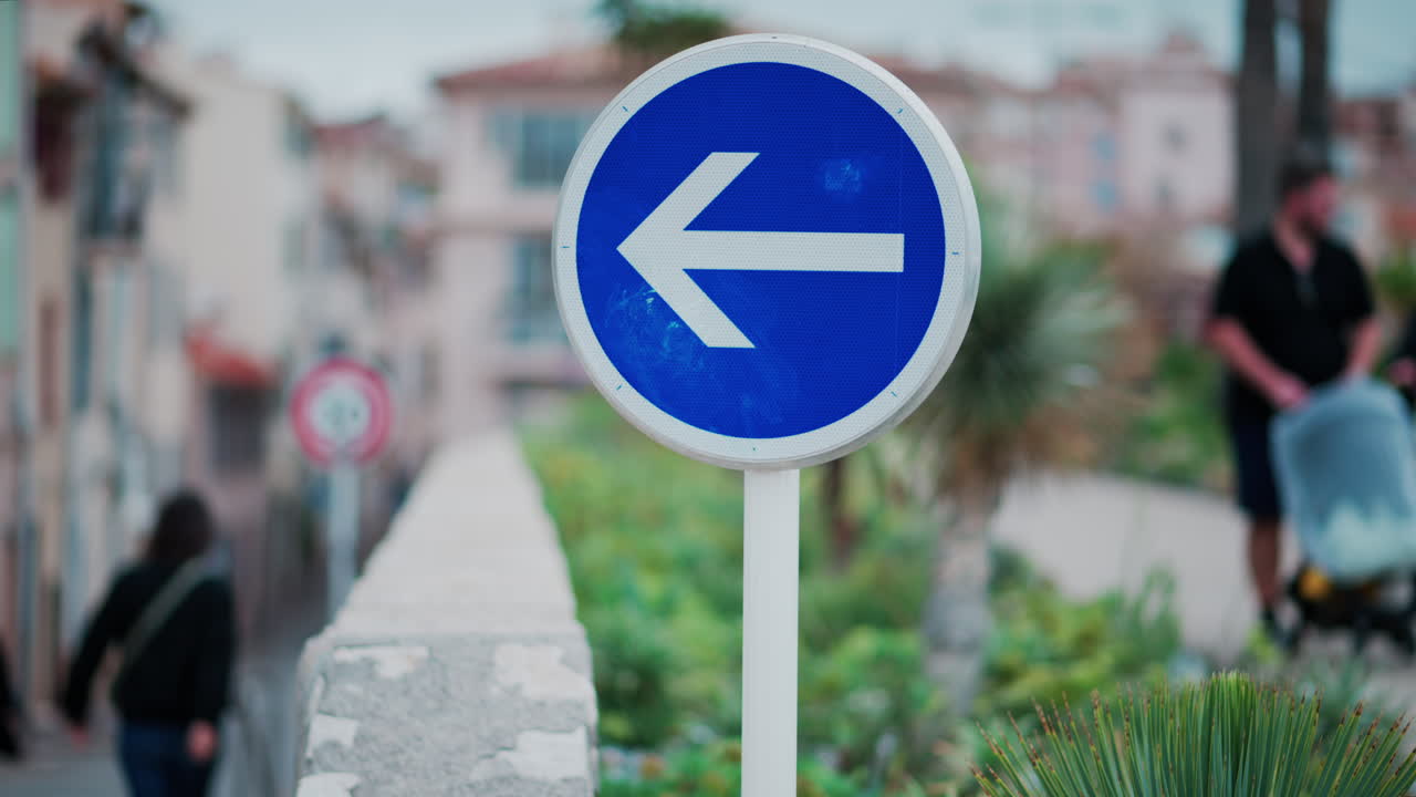 Direction sign on the street with a blurry background in Cannes, France