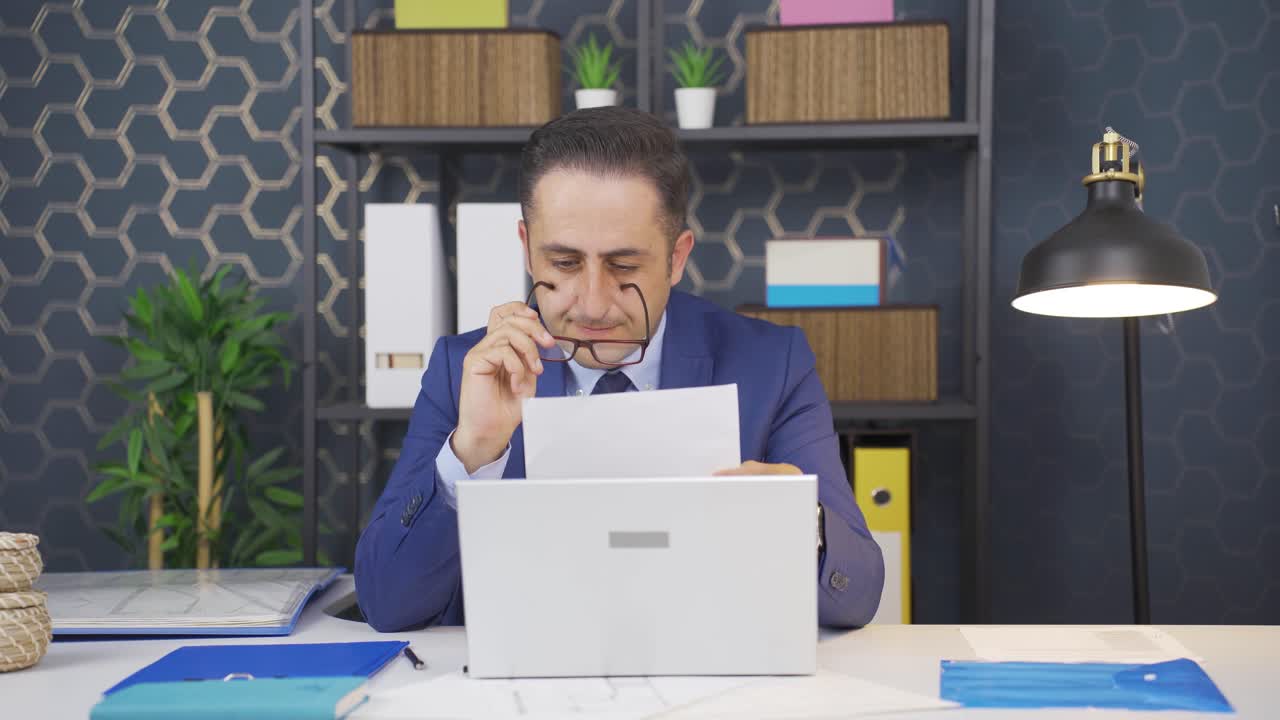 Businessman thinks looking at documents.