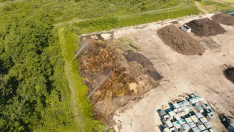 pile of green waste that is watered to increase rotting