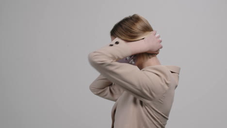 female model in stylish face mask dancing and posing